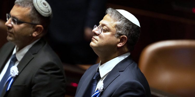 Israeli right wing Knesset member Itamar ben Gvir (C)attends the swearing in ceremony of the new Israeli government at the Knesset (Israeli parliament) in Jerusalem, on November 15, 2022. - Israel swore in a new parliament today hours after a deadly attack, as veteran hawk Benjamin Netanyahu advances talks on forming what could be the country's most right-wing government ever. (Photo by Maya Alleruzzo / POOL / AFP)