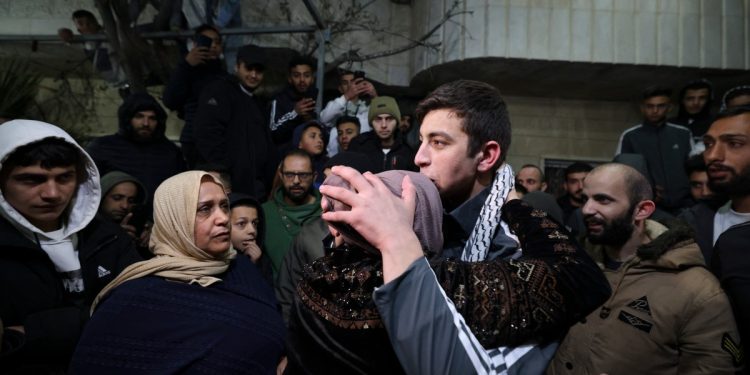 Palestinian prisoner Khalil Zama' (R) hugs his mother after being released from an Israeli jail in exchange for Israeli hostages released by Hamas from the Gaza Strip, at his home in Halhul village north Hebron in the occupied West Bank on November 27, 2023. - Israel's prison service said 39 Palestinian detainees were released on November 26, 2023 under the terms of a truce agreement between Israel and Hamas in the Gaza Strip. The announcement came after 13 Israeli hostages were freed in the Palestinian territory under the deal, along with three Thais and a Russian-Israeli dual citizen. (Photo by HAZEM BADER / AFP)