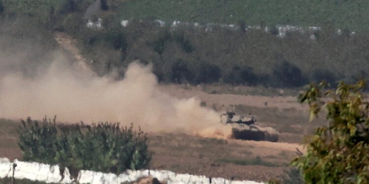 An Israeli tank manoeuvres at the border between Israel and the Gaza Strip, as seen from Sderot in southern Israel, November 8, 2023. REUTERS/Ammar Awad