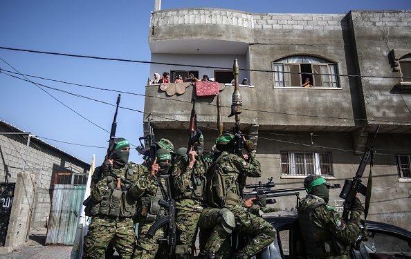 GAZA, PALESTINE - 2021/05/29: Masked activists of the Izz al-Din al-Qassam Brigades on a truck during an anti-Israel military parade in Rafah, in the southern Gaza Strip. (Photo by Yousef Masoud/SOPA Images/LightRocket via Getty Images)