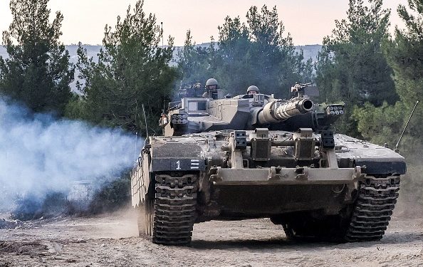 An Israeli army battle tank moves at a position in the upper Galilee region of northern Israel near the border with Lebanon on November 1, 2023 amid increasing cross-border tensions between Hezbollah and Israel as fighting continues in the south with Hamas militants in the Gaza Strip. (Photo by Jalaa MAREY / AFP) (Photo by JALAA MAREY/AFP via Getty Images)