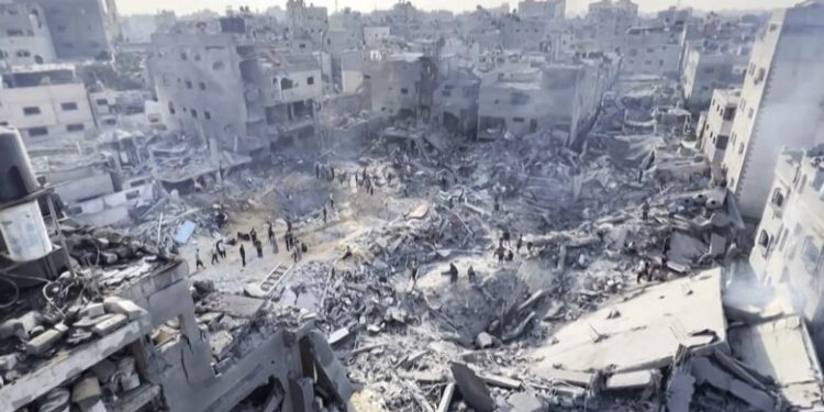 This image grab taken from AFPTV video footage shows Palestinians checking the destruction in the aftermath of an Israeli strike on the Jabalia refugee camp in the Gaza Strip, on November 1, 2023, amid ongoing battles between Israel and the Palestinian Hamas movement. Thousands of civilians, both Palestinians and Israelis, have died since October 7, 2023, after Palestinian Hamas militants based in the Gaza Strip entered southern Israel in an unprecedented attack triggering a war declared by Israel on Hamas with retaliatory bombings on Gaza. (Photo by AFP)