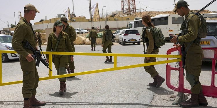 Israeli soldiers secure a gate leading to a military base following a deadly shootout in southern Israel along the Egyptian border, Saturday, June 3, 2023. (AP Photo/Tsafrir Abayov)