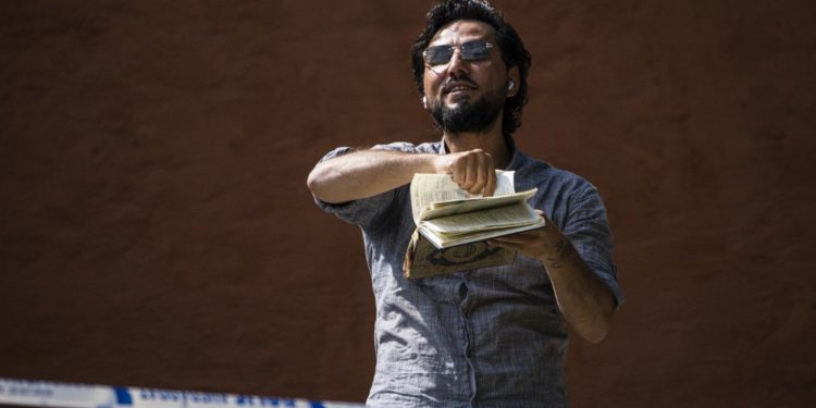 Salwan Momika protests outside a mosque in Stockholm on June 28, 2023, during the Eid al-Adha holiday. Momika, 37, who fled from Iraq to Sweden several years ago, was granted permission by the Swedish police to burn the Muslim holy book during the demonstration. (Photo by Jonathan NACKSTRAND / AFP)